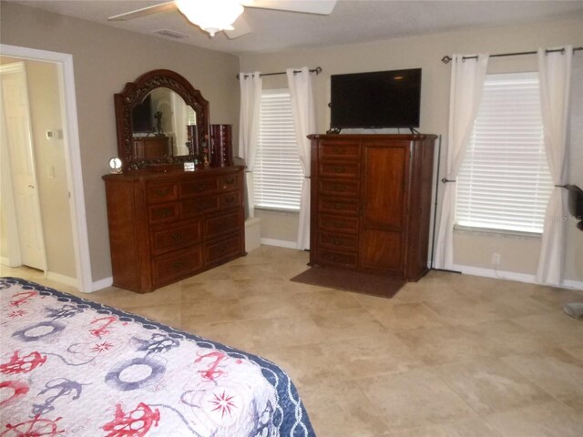 bedroom with ceiling fan and light tile patterned flooring