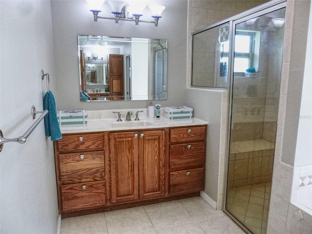 bathroom with vanity, a shower with door, and tile patterned flooring