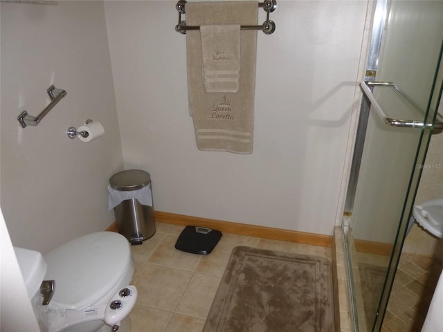 bathroom with toilet and tile patterned flooring