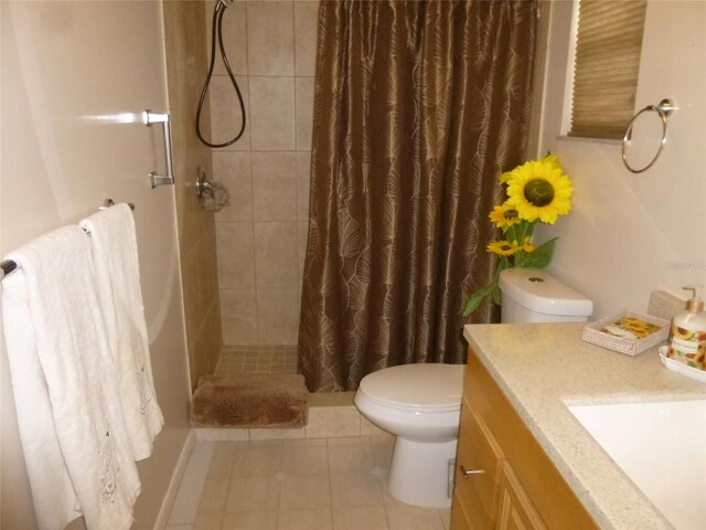 bathroom featuring curtained shower, tile patterned floors, vanity, and toilet