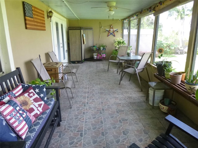 sunroom featuring ceiling fan