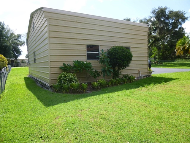 view of property exterior with a lawn