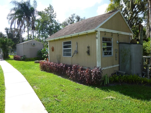 view of side of home with a yard