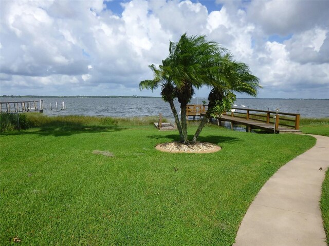 exterior space featuring a lawn and a water view