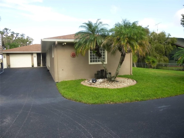 view of front of house featuring a garage and a front lawn