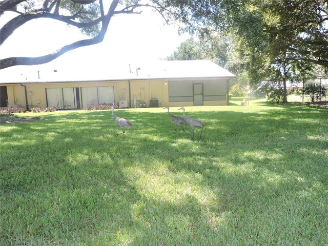 view of yard with central AC