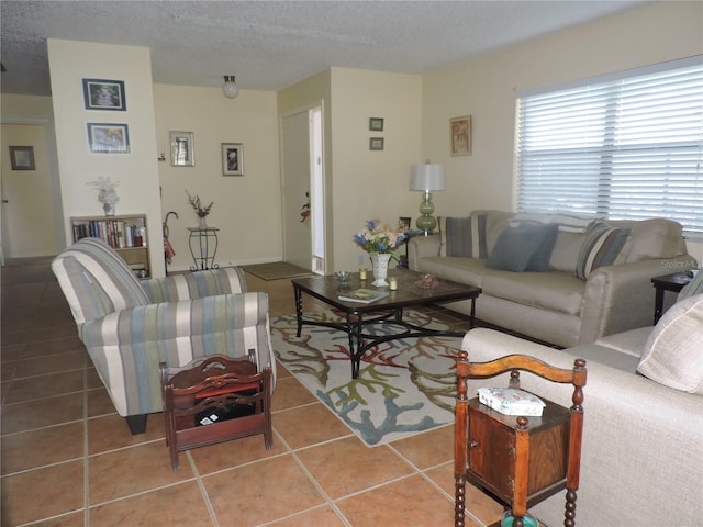 living room featuring a textured ceiling and tile patterned floors