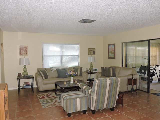 living room featuring tile patterned floors and a textured ceiling