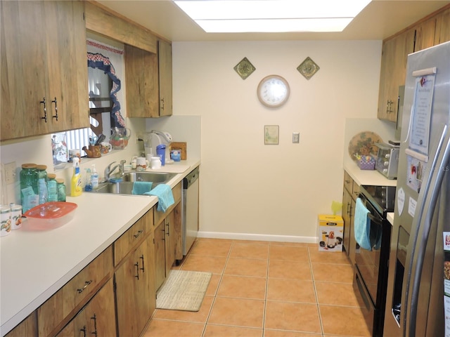 kitchen with sink, appliances with stainless steel finishes, and light tile patterned floors