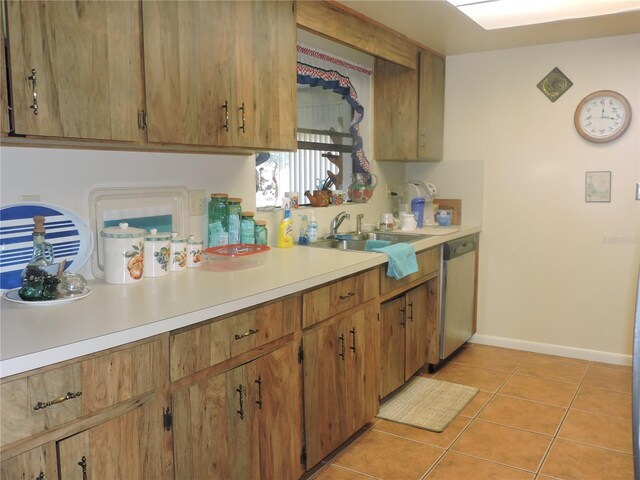 kitchen with sink, light tile patterned floors, and dishwasher