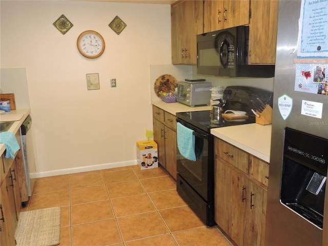 kitchen featuring light tile patterned flooring and black appliances