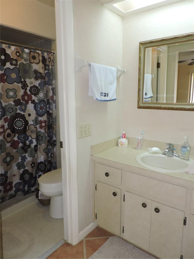 bathroom with vanity, toilet, tile patterned floors, and a shower with shower curtain