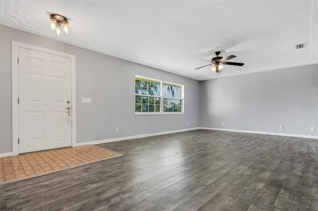 foyer entrance with ceiling fan, a textured ceiling, visible vents, and dark wood-type flooring