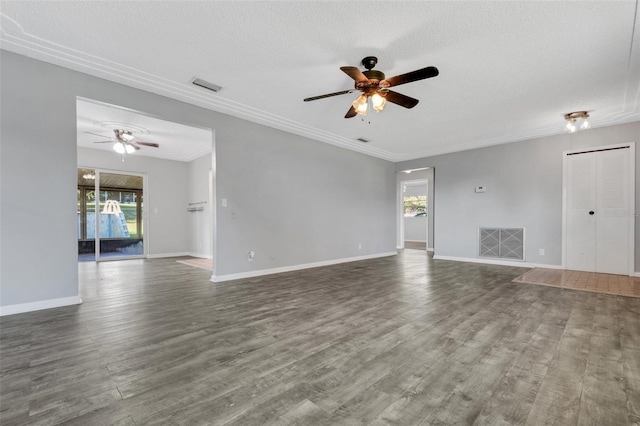 unfurnished living room with dark wood-style flooring, visible vents, a textured ceiling, and baseboards