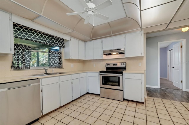 kitchen featuring appliances with stainless steel finishes, white cabinets, light countertops, and under cabinet range hood