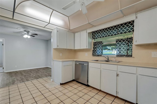 kitchen featuring a sink, white cabinetry, light countertops, and stainless steel dishwasher