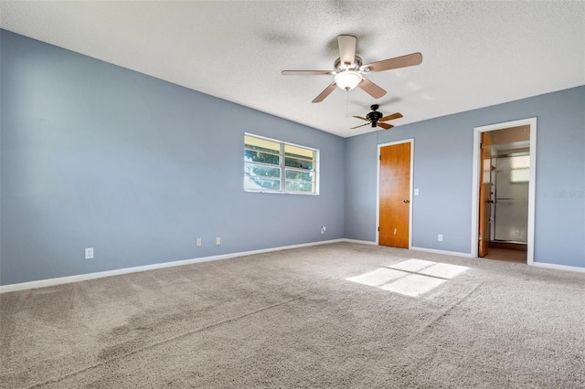 unfurnished bedroom with a textured ceiling, ensuite bathroom, carpet flooring, a ceiling fan, and baseboards