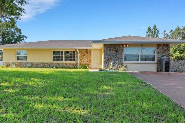 single story home featuring stone siding and a front lawn