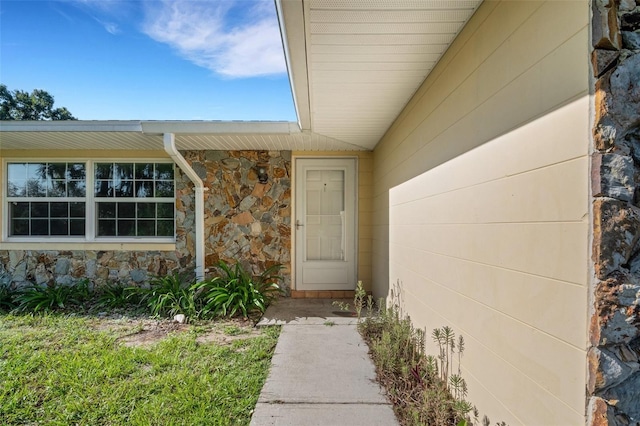 entrance to property featuring stone siding