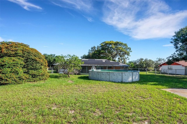 view of yard featuring fence and an outdoor pool