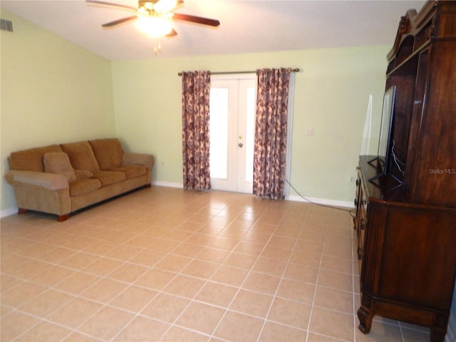 living room featuring ceiling fan, french doors, and light tile patterned floors