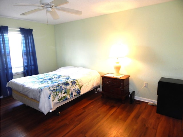 bedroom with dark hardwood / wood-style floors and ceiling fan