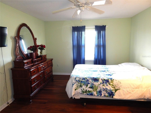 bedroom with ceiling fan and dark hardwood / wood-style flooring