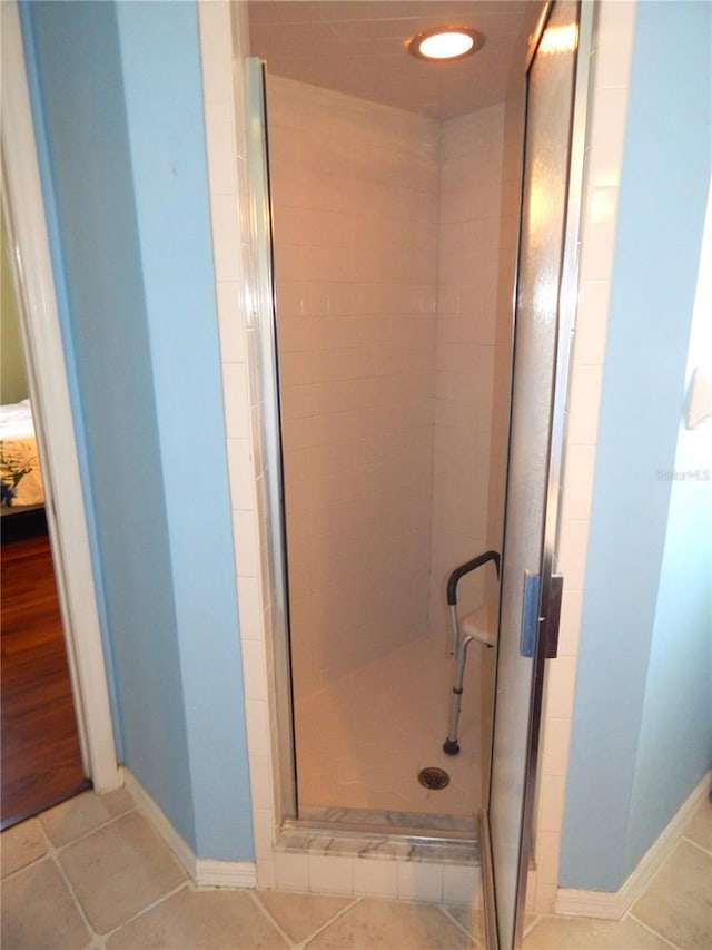 bathroom with walk in shower and wood-type flooring