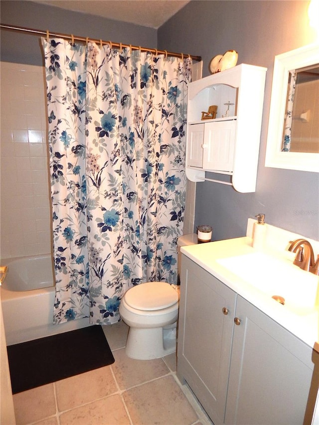 full bathroom with toilet, shower / bath combo with shower curtain, vanity, and tile patterned floors