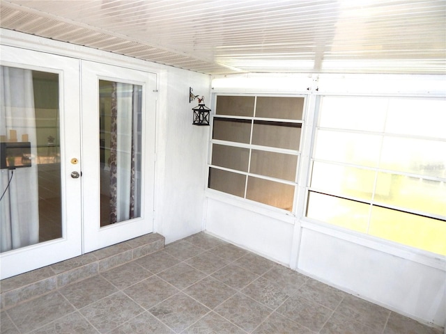 unfurnished sunroom featuring french doors