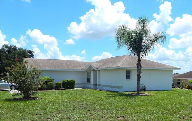 rear view of property with a lawn