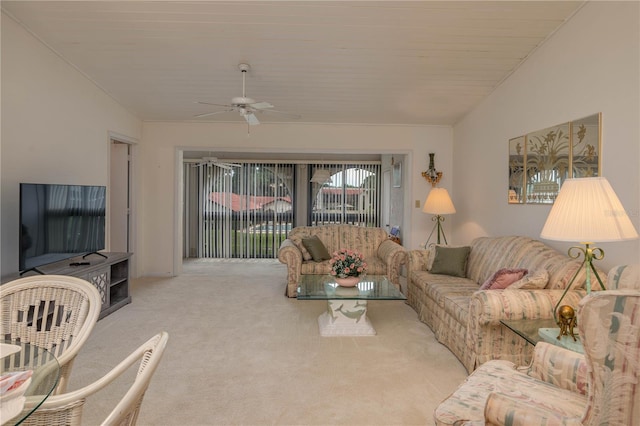 living room featuring lofted ceiling, carpet floors, and a ceiling fan