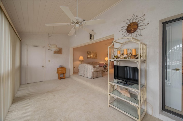 interior space with lofted ceiling, ceiling fan, wooden ceiling, and carpet flooring