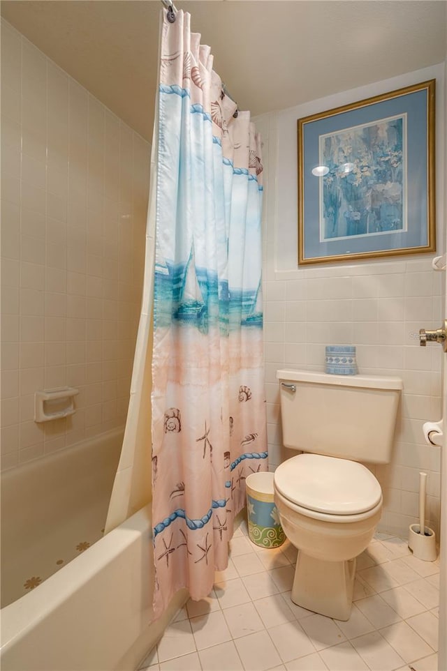 full bath with toilet, tile patterned flooring, shower / bath combo, and tile walls