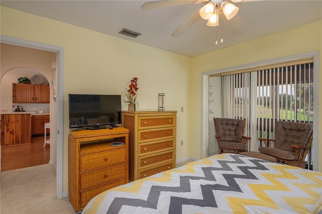 bedroom with access to exterior, visible vents, ceiling fan, and light carpet