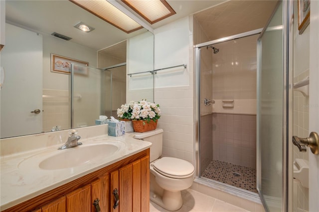 full bath with tile patterned flooring, toilet, visible vents, tile walls, and a shower stall