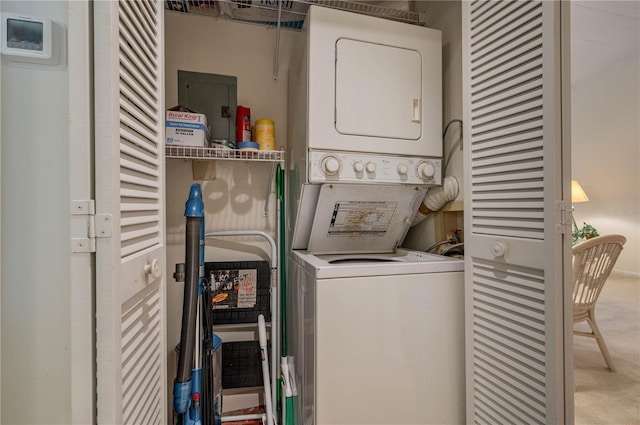 laundry room with stacked washer and clothes dryer and laundry area