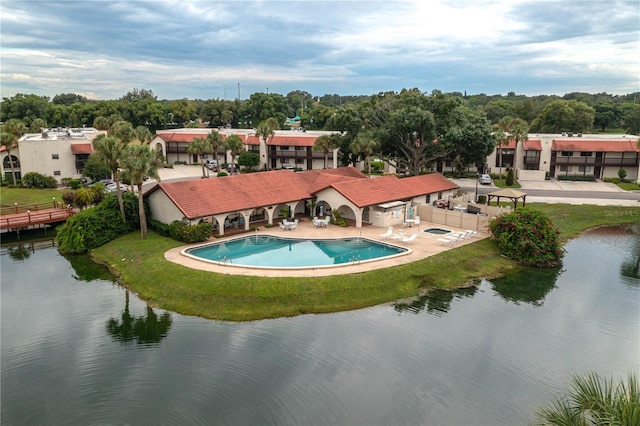 exterior space featuring a yard, a water view, a patio, and fence