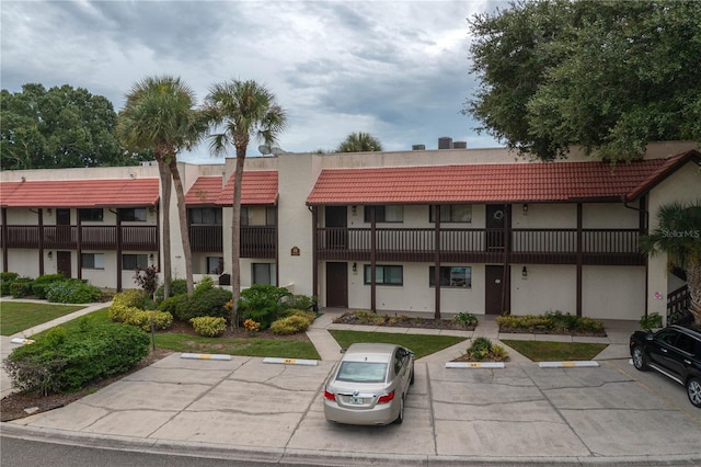 view of property featuring uncovered parking