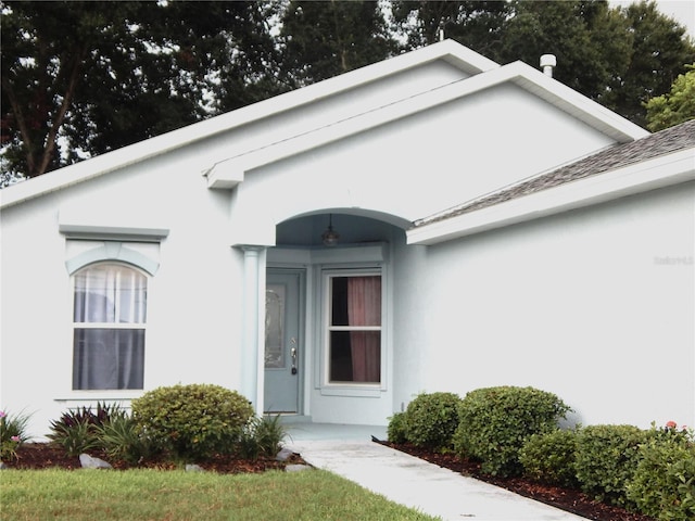 doorway to property with stucco siding