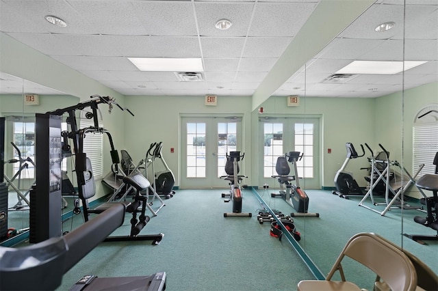 exercise room with french doors, visible vents, and a drop ceiling