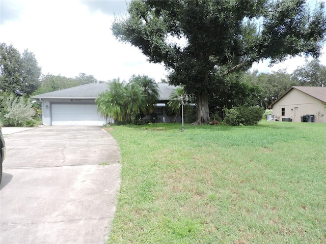 view of front of house with a garage and a front lawn