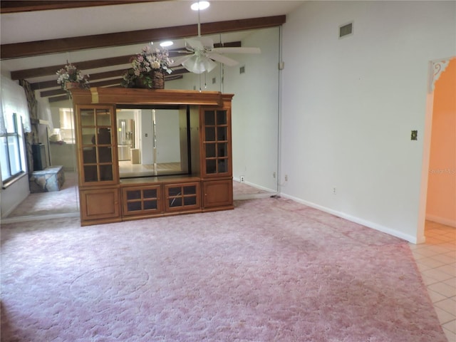 unfurnished living room featuring ceiling fan, lofted ceiling with beams, and tile patterned flooring