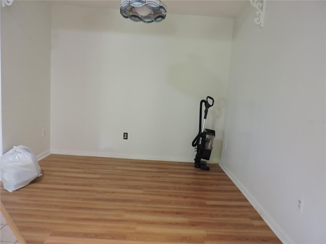 clothes washing area with hardwood / wood-style floors