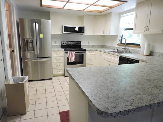 kitchen featuring white cabinets, light tile patterned floors, sink, kitchen peninsula, and stainless steel appliances