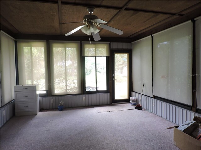 unfurnished sunroom featuring ceiling fan and wood ceiling