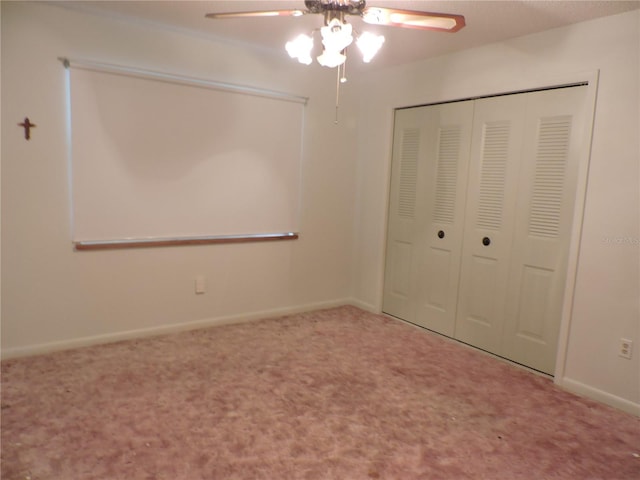 unfurnished bedroom featuring ceiling fan, a closet, and carpet