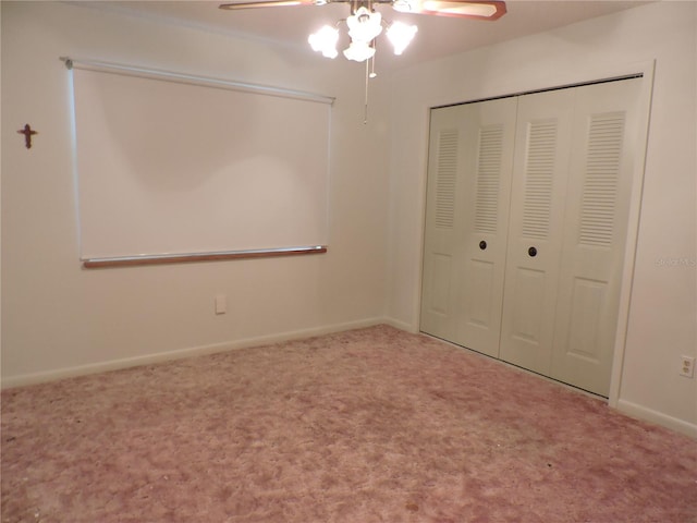 unfurnished bedroom featuring carpet flooring, ceiling fan, and a closet