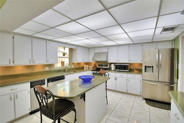 kitchen featuring white cabinets, stainless steel appliances, sink, and extractor fan