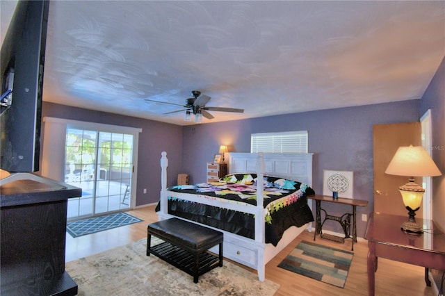 bedroom featuring hardwood / wood-style floors, ceiling fan, and access to exterior